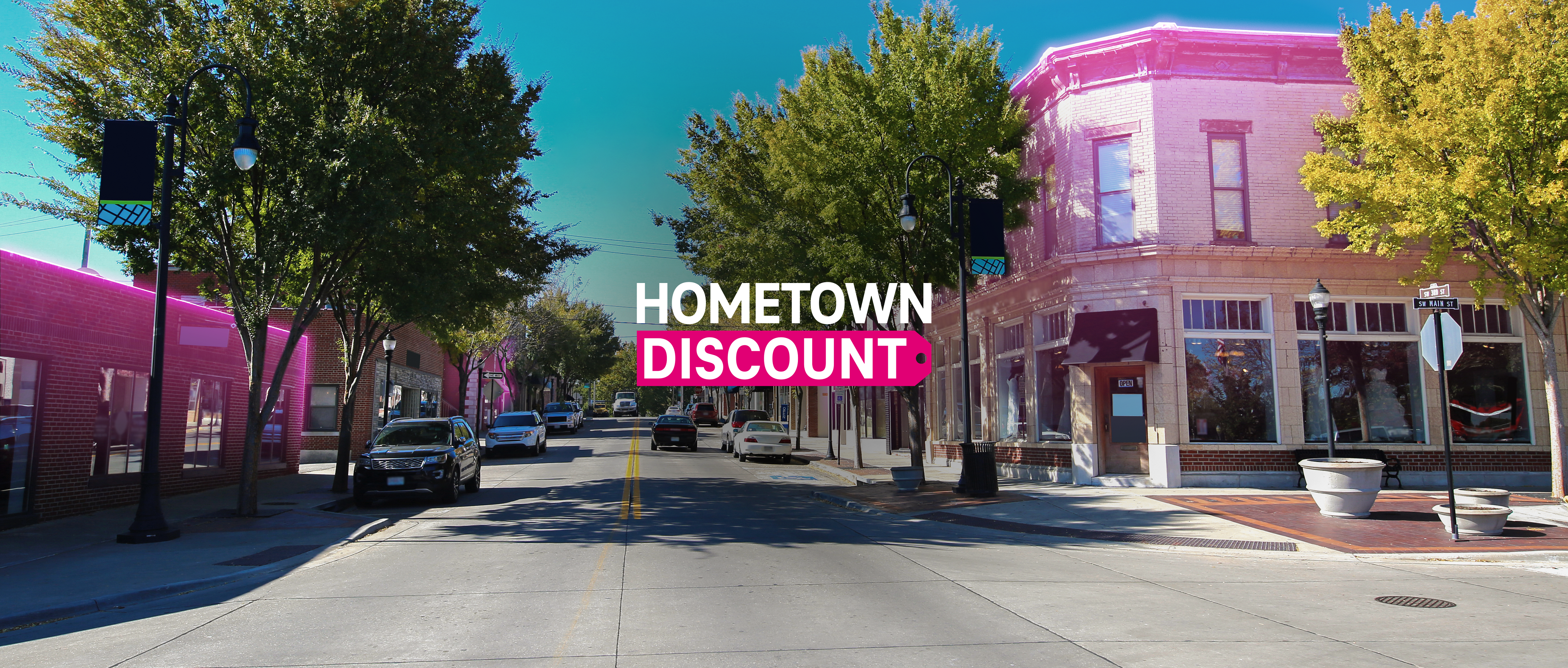 Main street in a small town with some buildings highlighted with magenta accents and the Hometown Discount logo overlayed