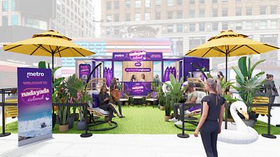 Metro's Nada Yada Island event with tropical theme, yellow umbrellas, seating, plants, and signage.