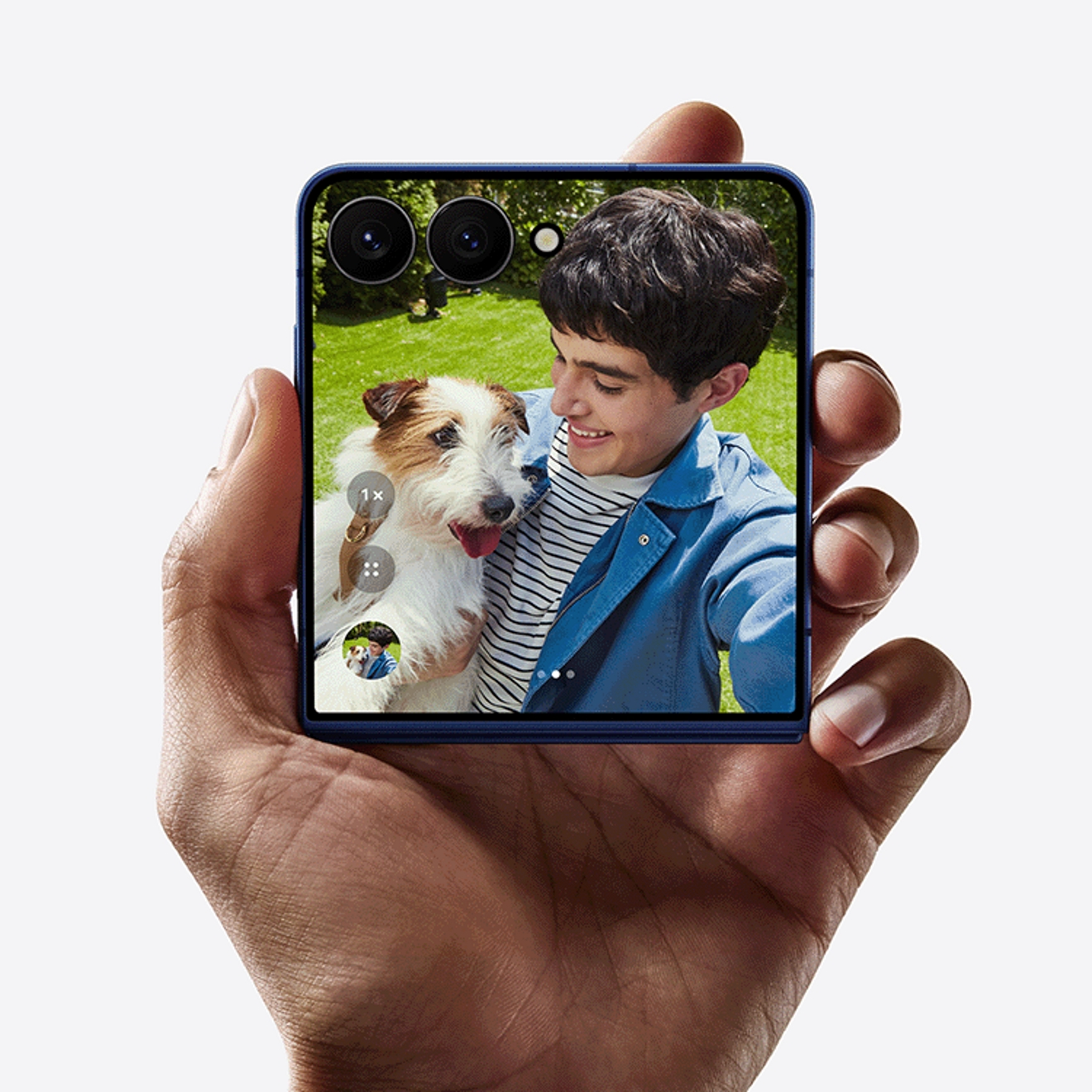 A folded Galaxy Z Flip7 displaying a photo of a boy and his dog on the outer screen.