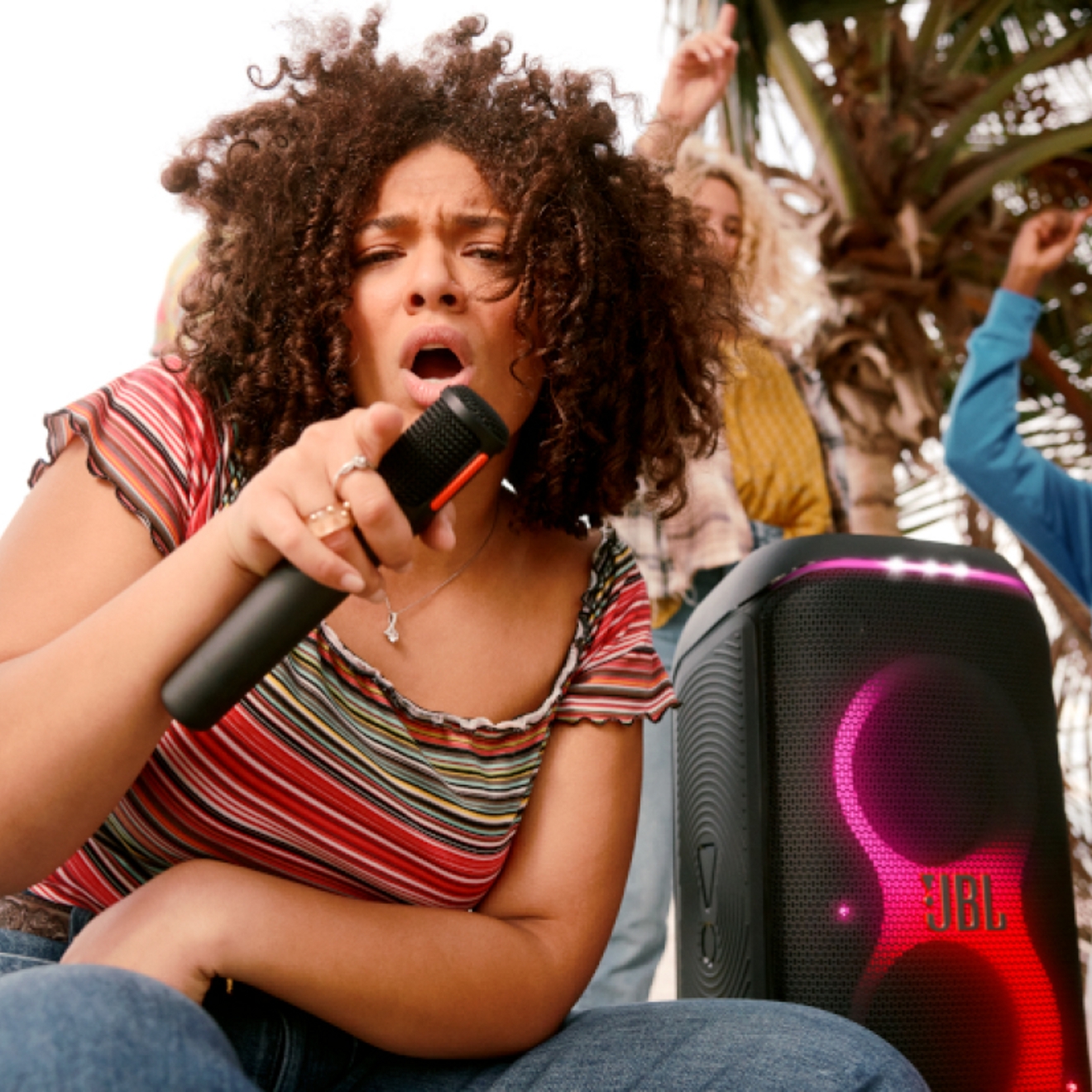 A person singing using their JBL PartyBox Club 120