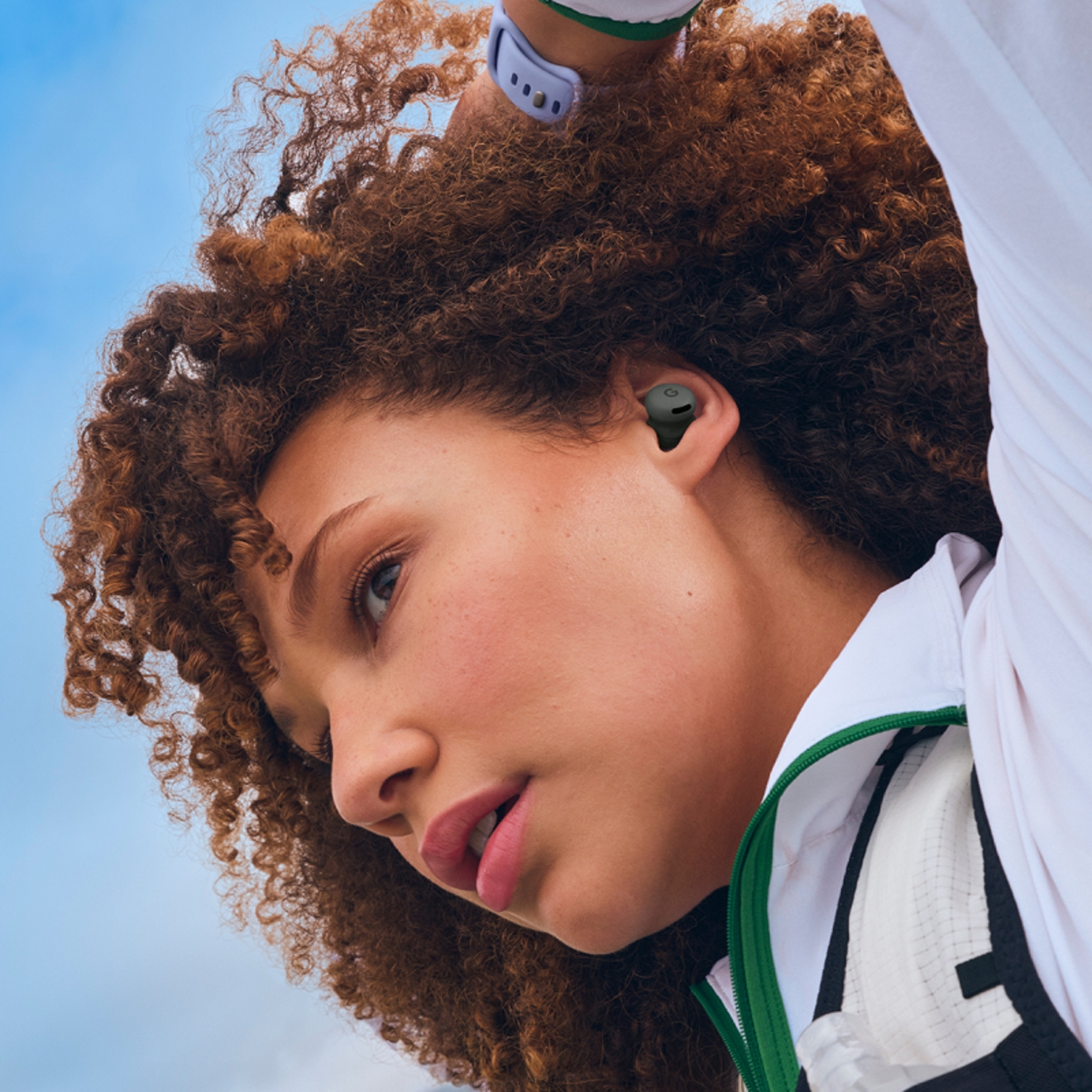 Woman listening to Google Pixel Buds 2a device