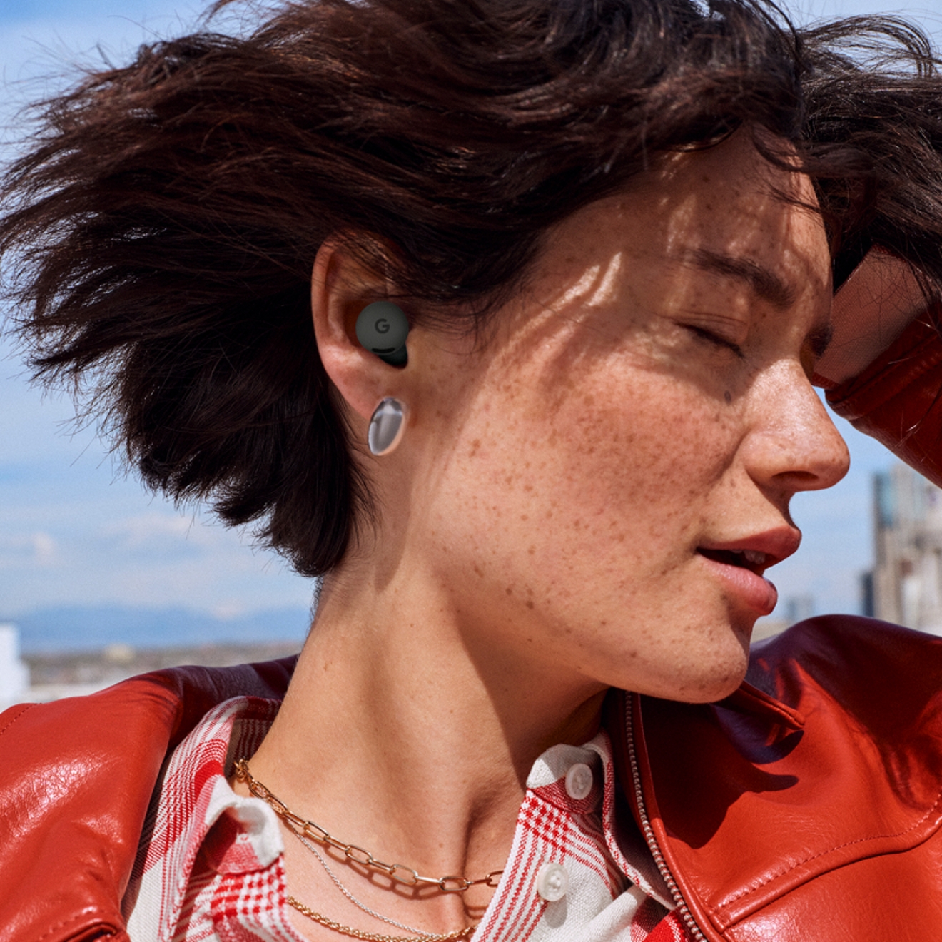 A woman using Google Pixel Buds 2a device