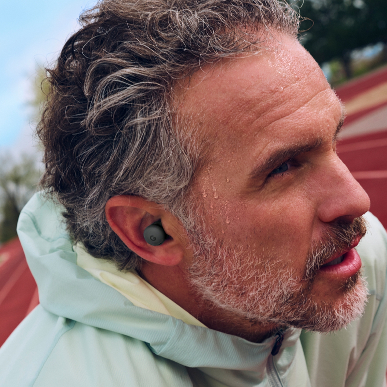 A man using Google Pixel Buds 2a device