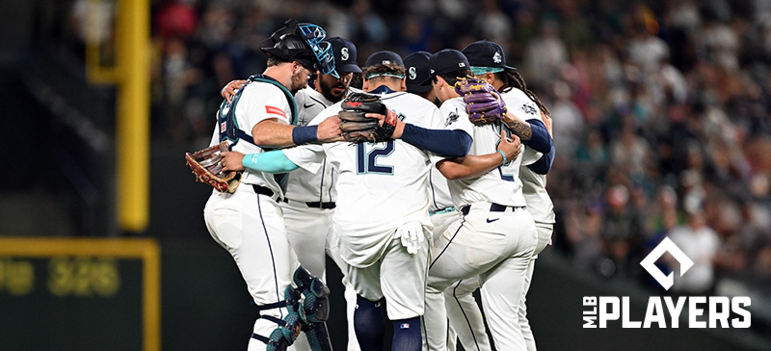 Baseball players huddling during a game.