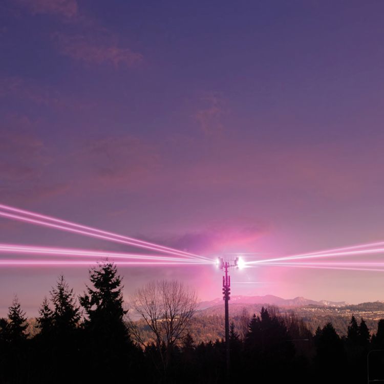 Torre de red 5G con haces de luz que cruzan el cielo.
