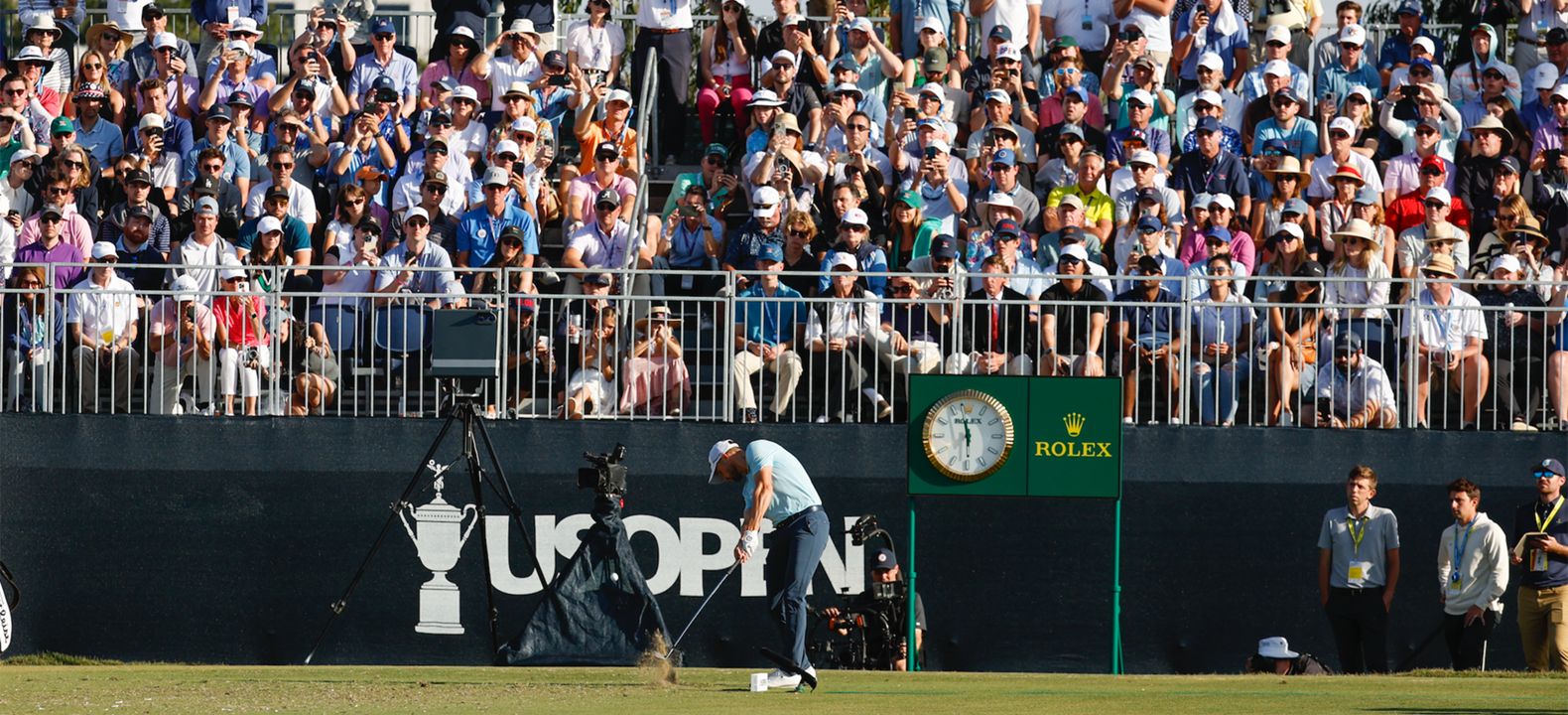 Golf fans cheering from the grandstands at the U.S. Open.