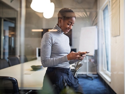 A businessperson uses their Galaxy AI agent to search across multiple Galaxy apps at the same time.