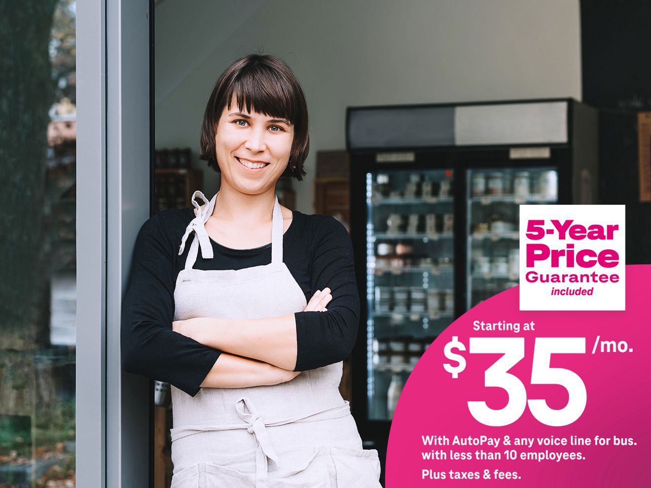 Woman in apron in front of store entrance