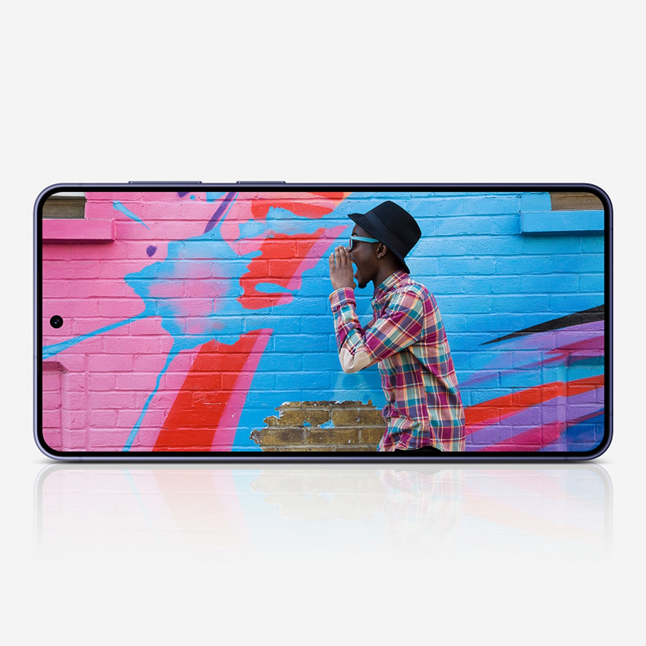 Person posing in front of a vibrantly colored wall