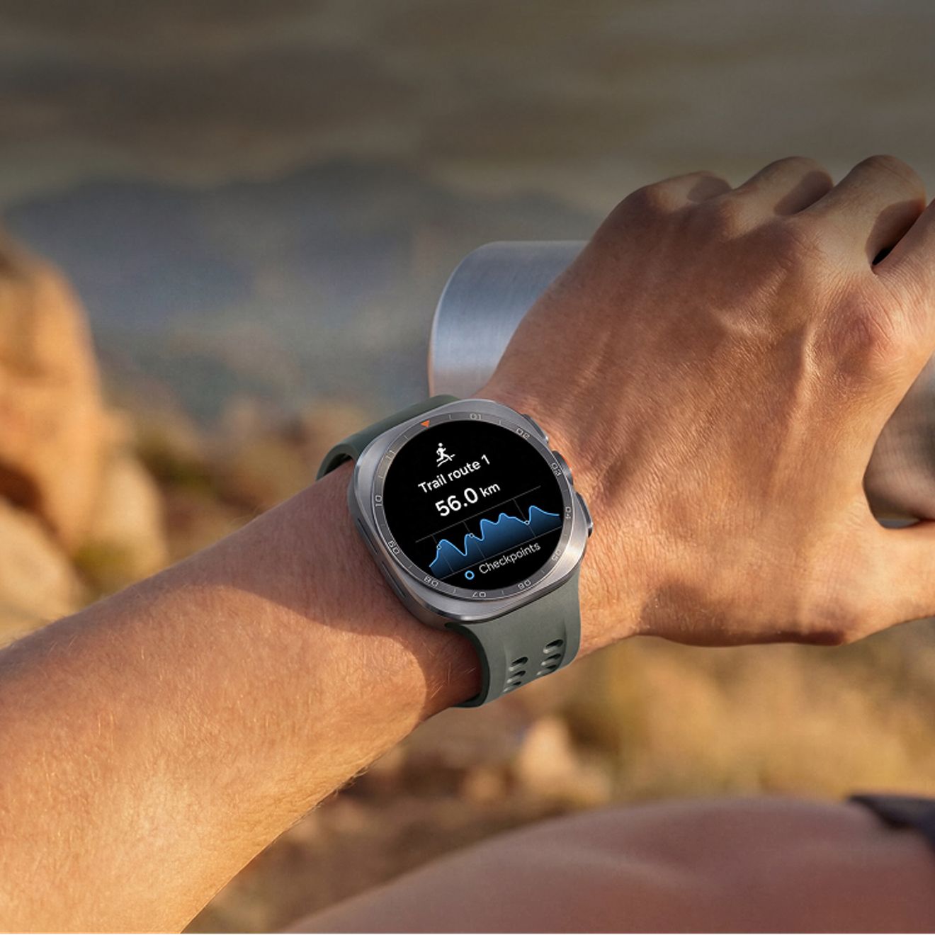Galaxy watch ultra two worn during a hike displays a trail route, elevation profile, and checkpoints for outdoor navigation.