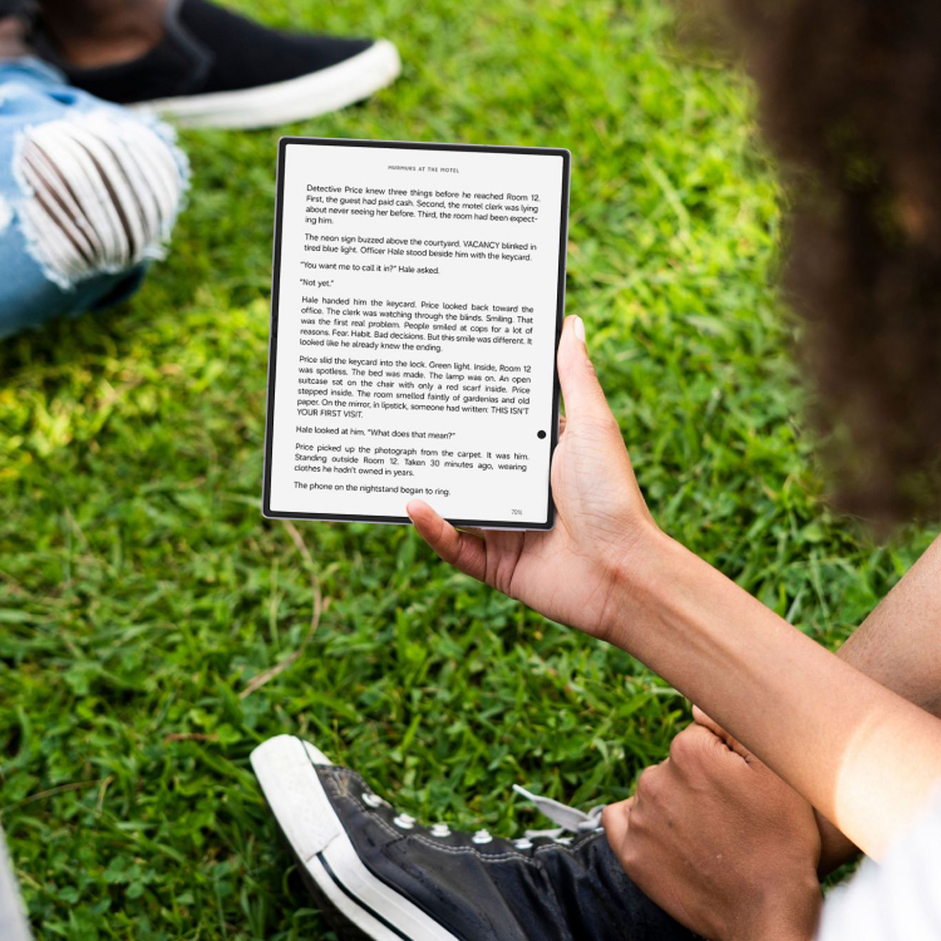 Samsung Galaxy Z Fold8 held outdoors, displaying an e-book on the large foldable screen while resting in one hand.