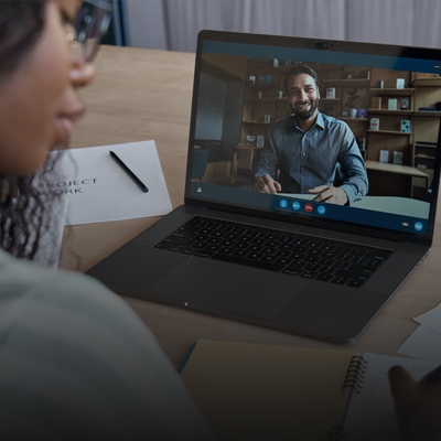 Student using laptop for video call with tutor.