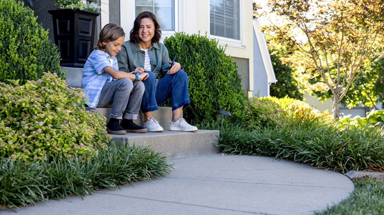 Image of parent and child on a front stoop.