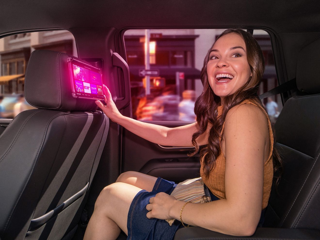 Woman uses T-Mobile Advertising Solutions tablet in backseat of rideshare vehicle.