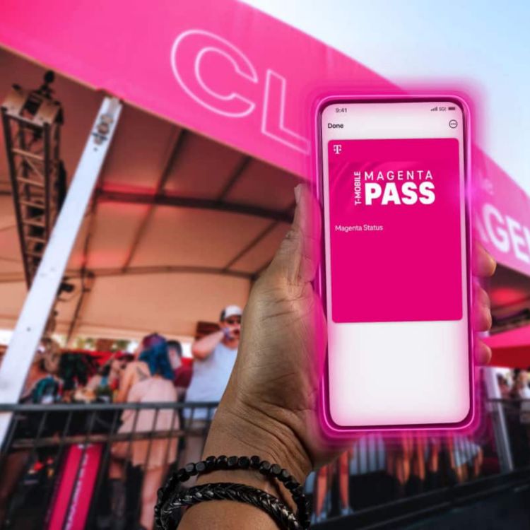 A concertgoer’s hand holds up a smartphone with T-Mobile’s Magenta Pass onscreen.