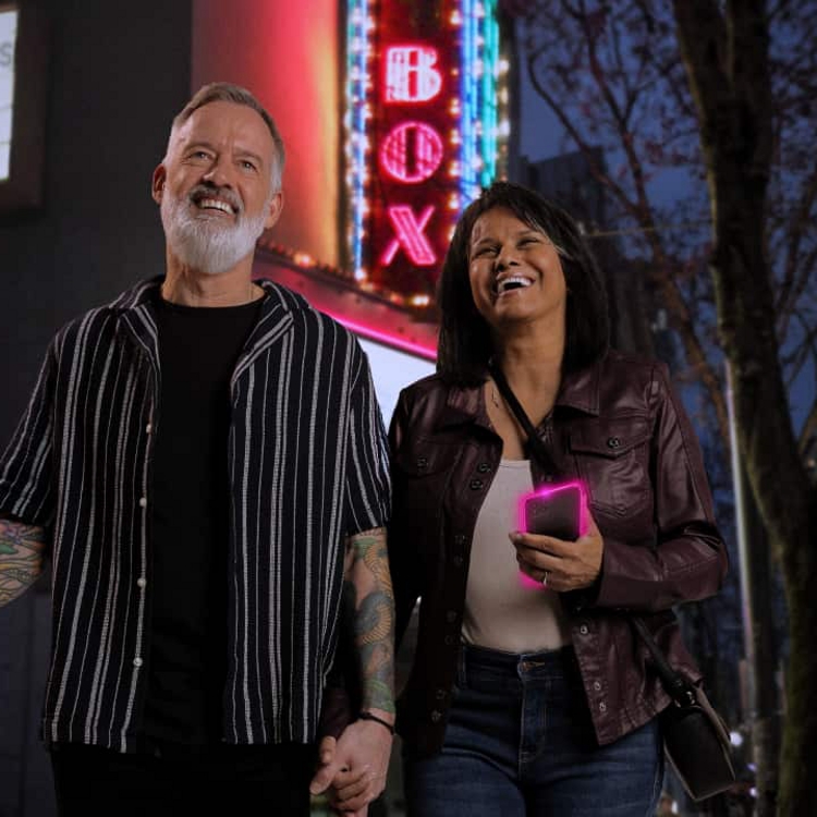 Two happy moviegoers leave the theater.