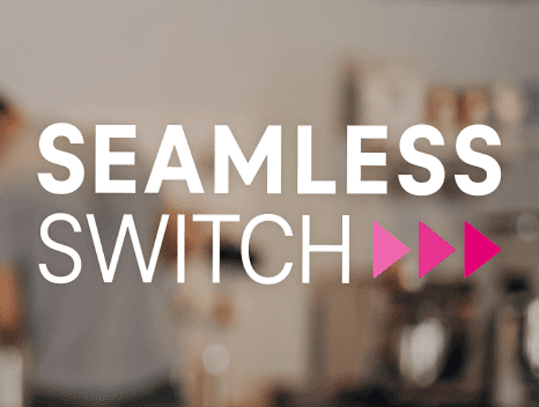 The Seamless Switch logo on a blurred background of a young man in an indoor setting.