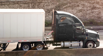 A semi-truck on a highway.