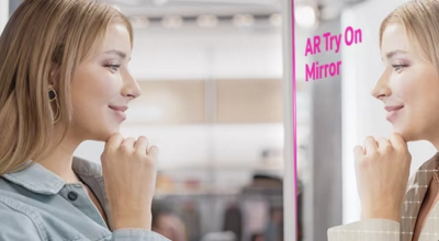 A woman uses an AR try-on mirror.