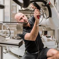 A man building a robotic arm