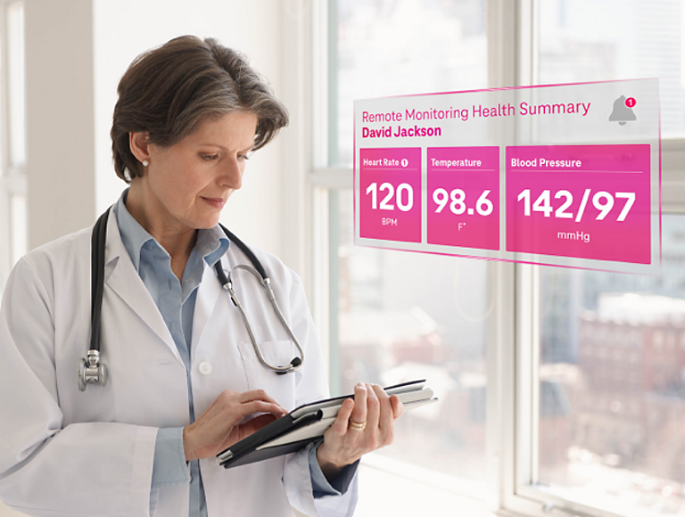 Doctor looks at a tablet with a patient’s health summary information on screen