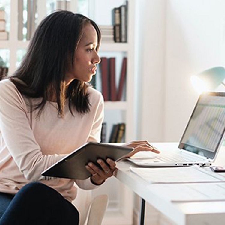 Man and woman, both in business attire, wear VR headsets.