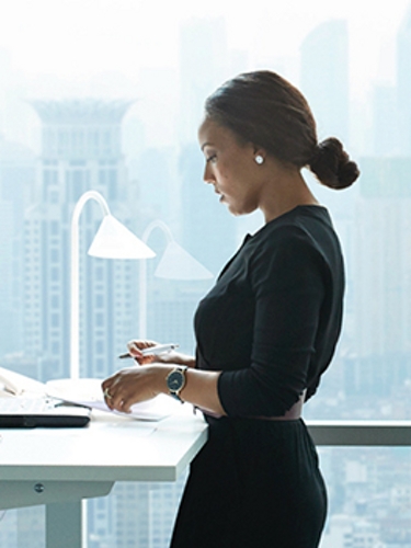 Man and woman, both in business attire, wear VR headsets.