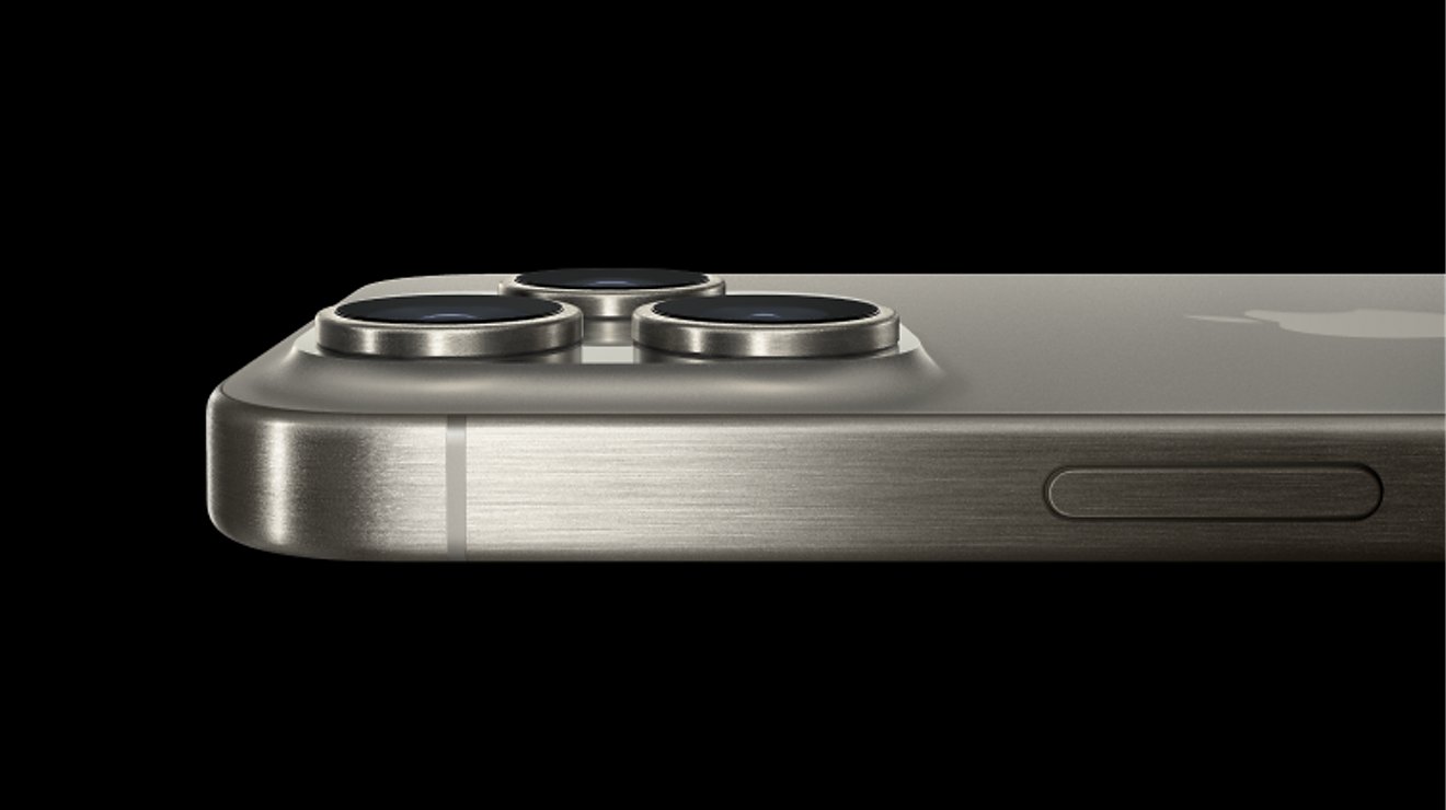 The Titanium iPhone 15 Pro logo over two Titanium iPhone 15 Pro devices shown at an angle.
