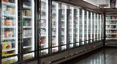 Sensor-equipped display cases line the frozen food aisle of a supermarket.