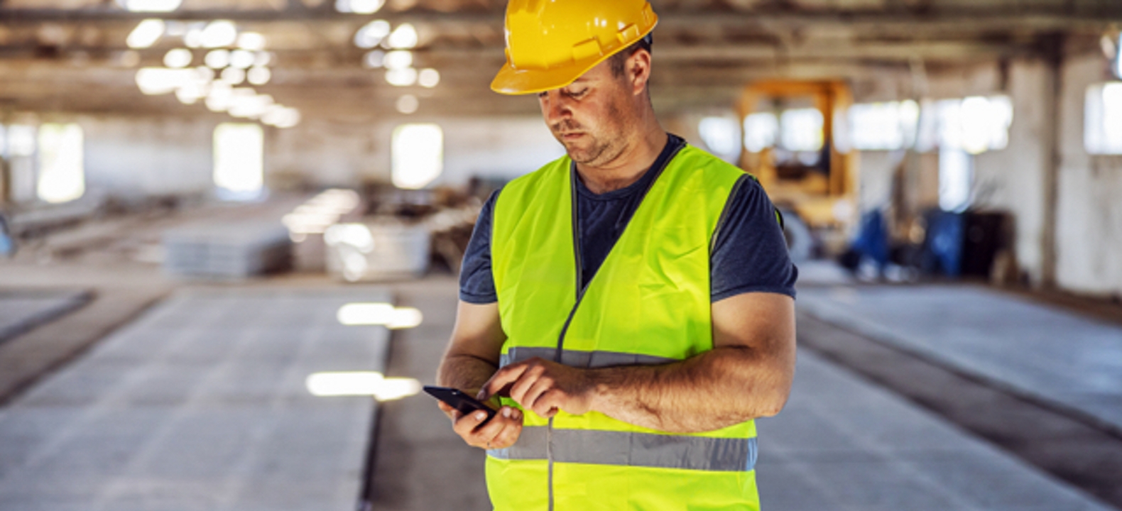 Smiling woman in white takes a piece of paper from a man in a blue shirt.