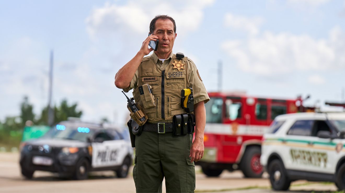 A sheriff's deputy connects over a secure smartphone from an incident scene.