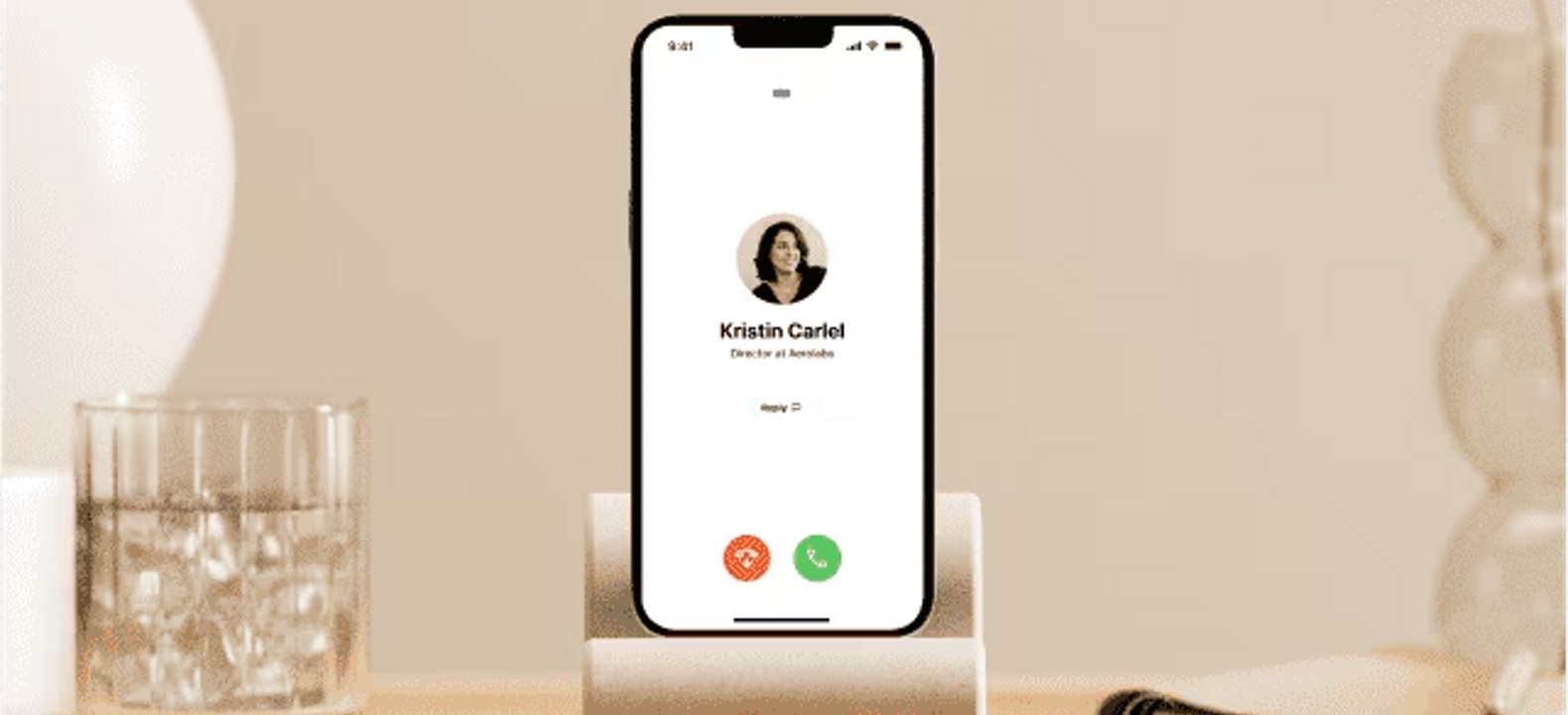 Incoming Dialpad voice call screen shown on an iPhone in a phone cradle.