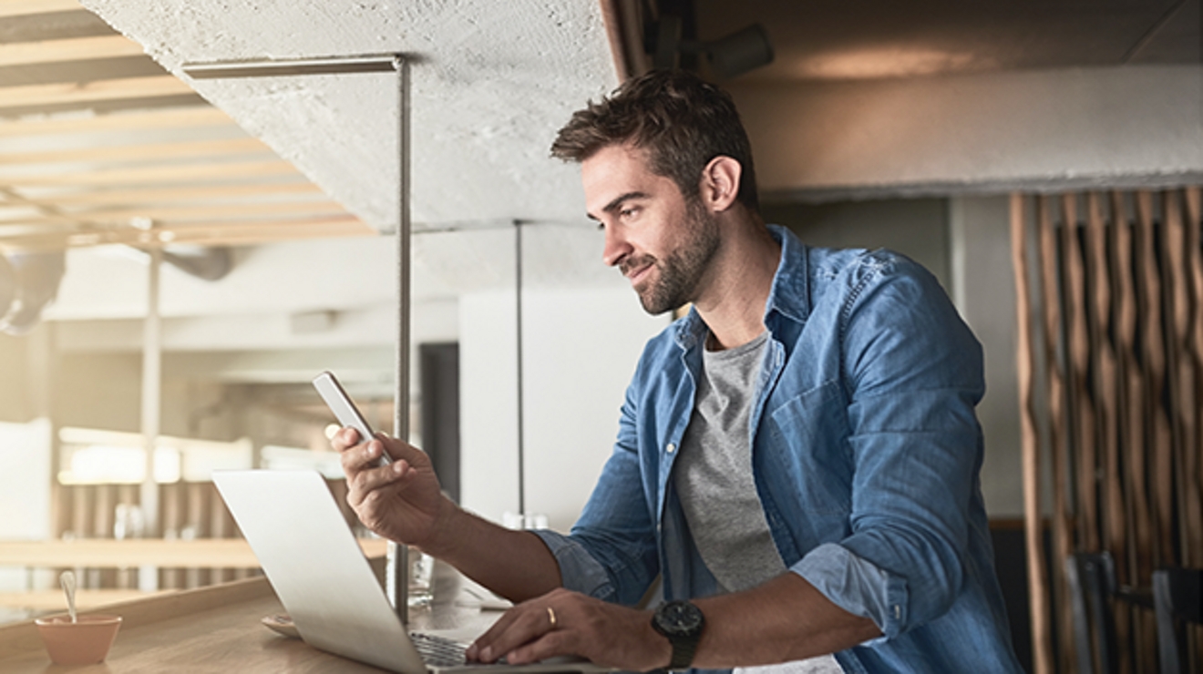 person viewing device while sitting at a laptop