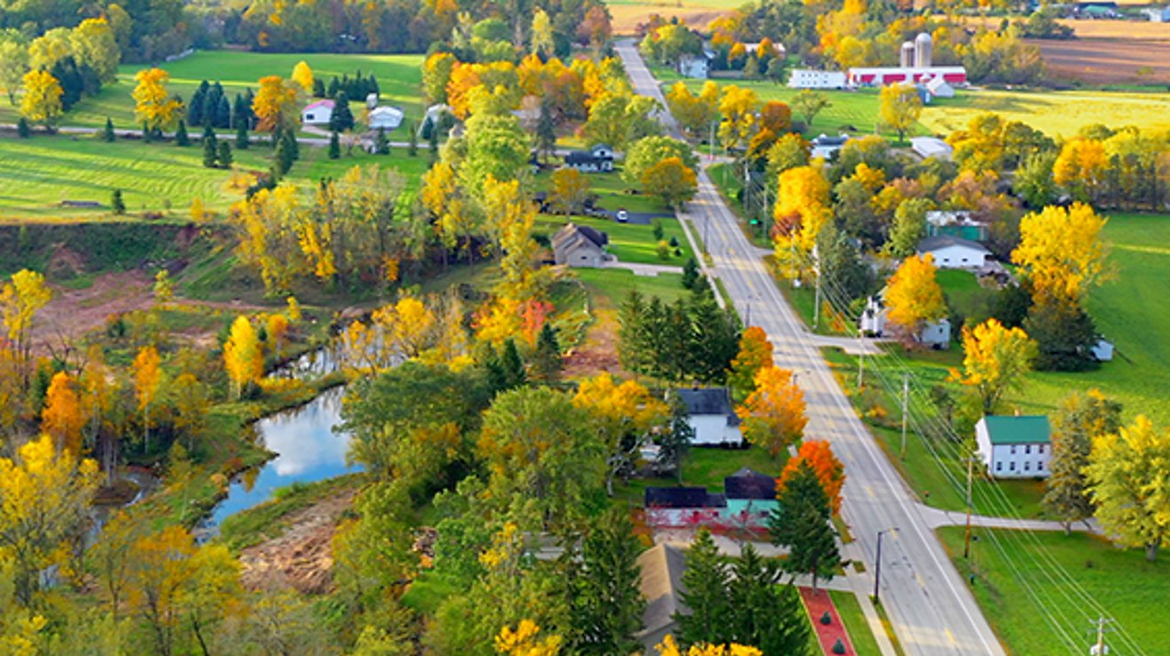 ariel view of a rural street during fall foliage