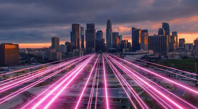 cityscape at dusk with magenta beams across