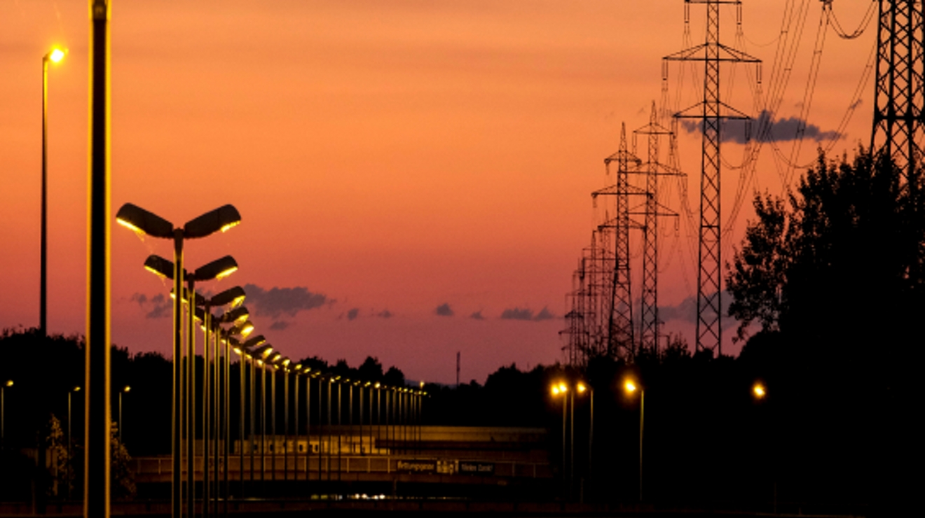Streetlights and powerlines at dusk.