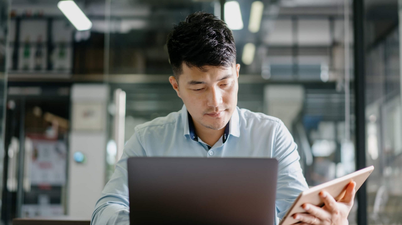 An employee works securely on their laptop and tablet.