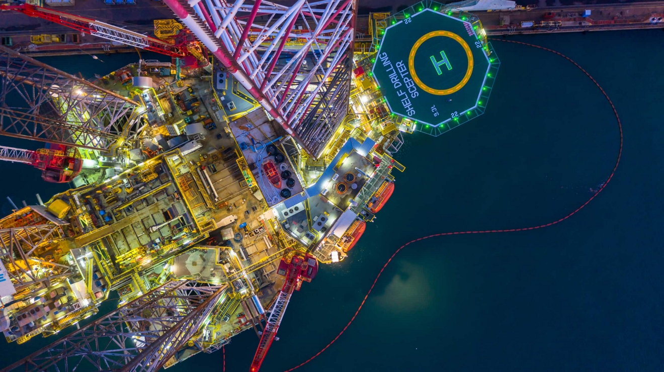 An aerial view of an offshore oil rig at night.