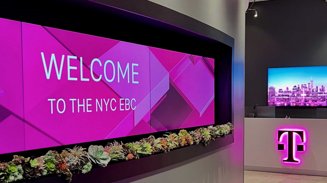A backlit magenta welcome sign greets visitors at the Executive Business Center in New York City.