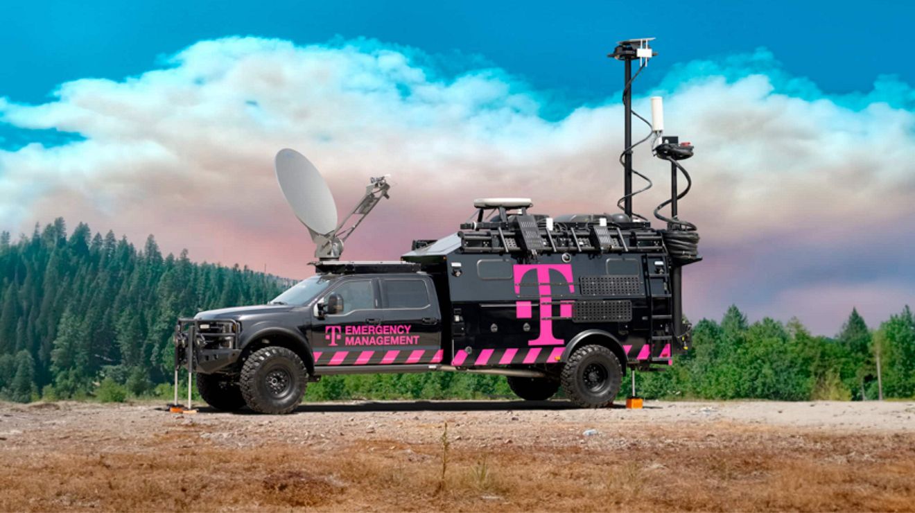 A T-Mobile emergency management truck in the wilderness with satellite dish and other gear in use.