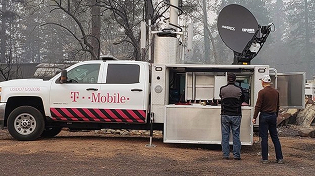 Two engineers working outside of a t-mobile work truck