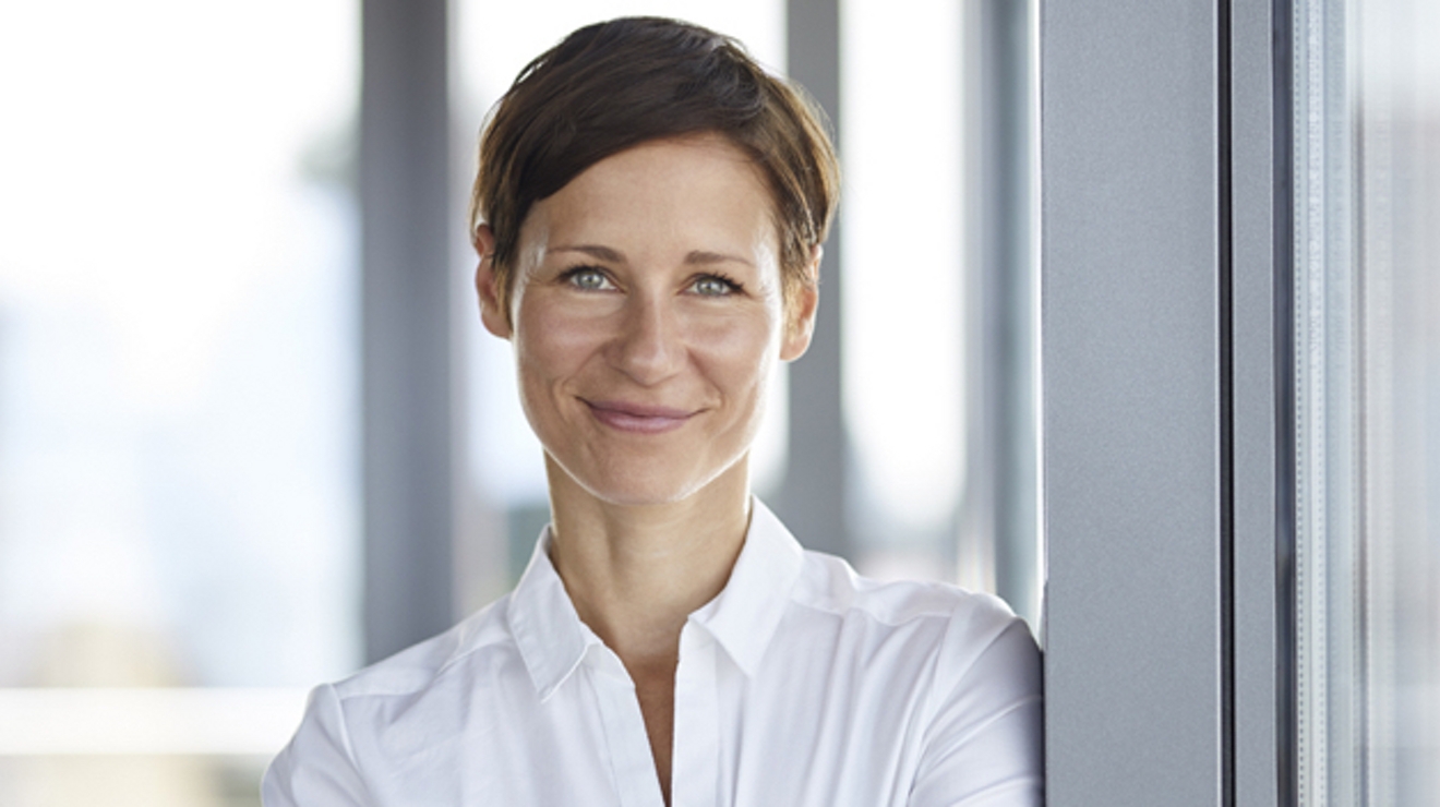 A government employee smiles at the camera.