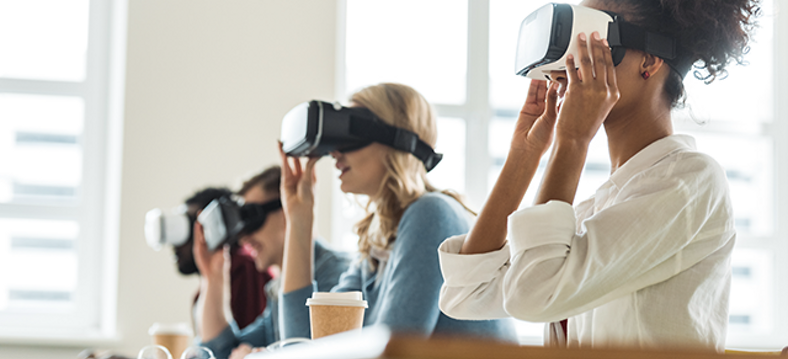 Individuals wear VR glasses in classroom