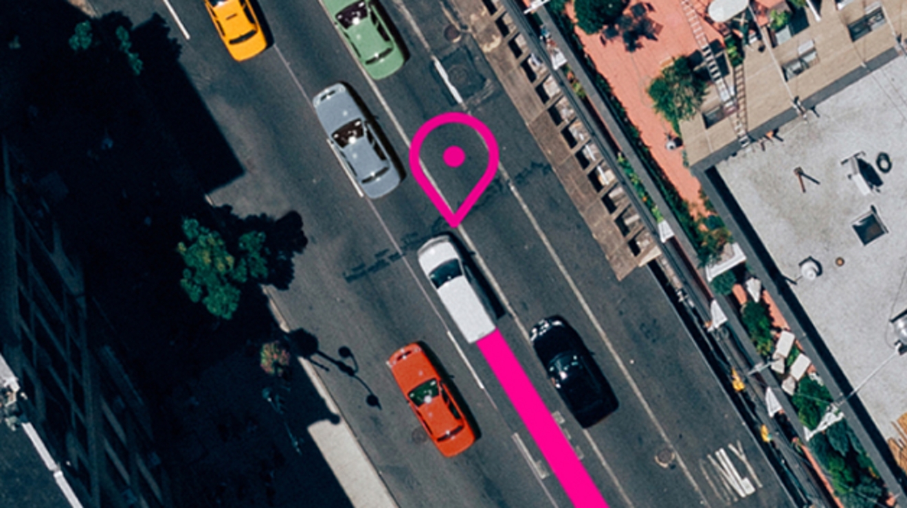 Overhead view of a vehicle on the road. A magenta location pin and path indicate fleet tracking.