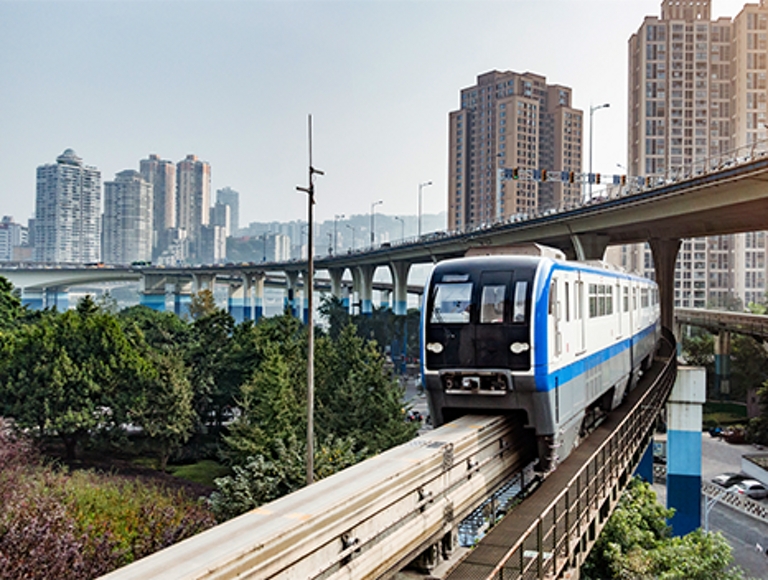Person in business clothing looks at their phone inside an open office.