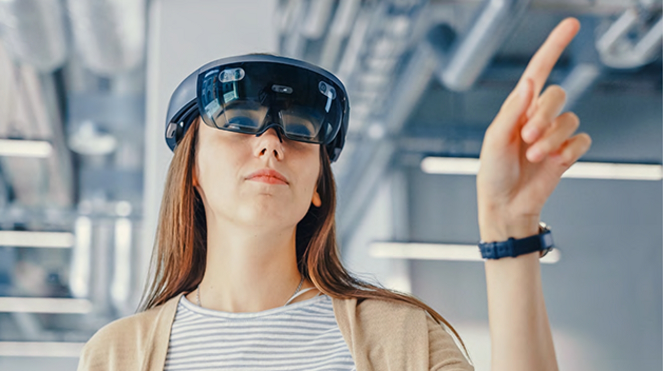 Woman in AR goggles gestures into the air.