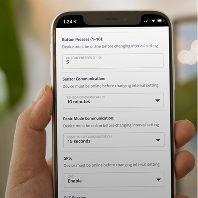 Hand holding a smartphone outdoors