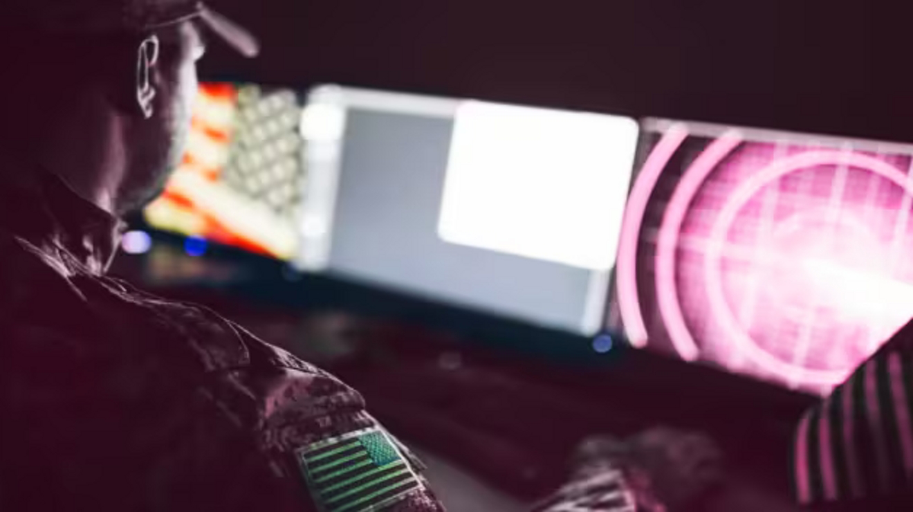 A seated military operator monitors a radar display. 