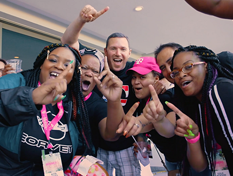 A group of enthusiastic T-Mobile employees and customers.