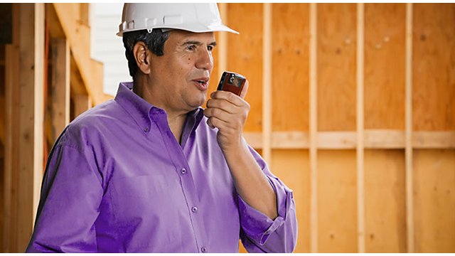 Man in white hard hat and purple button down